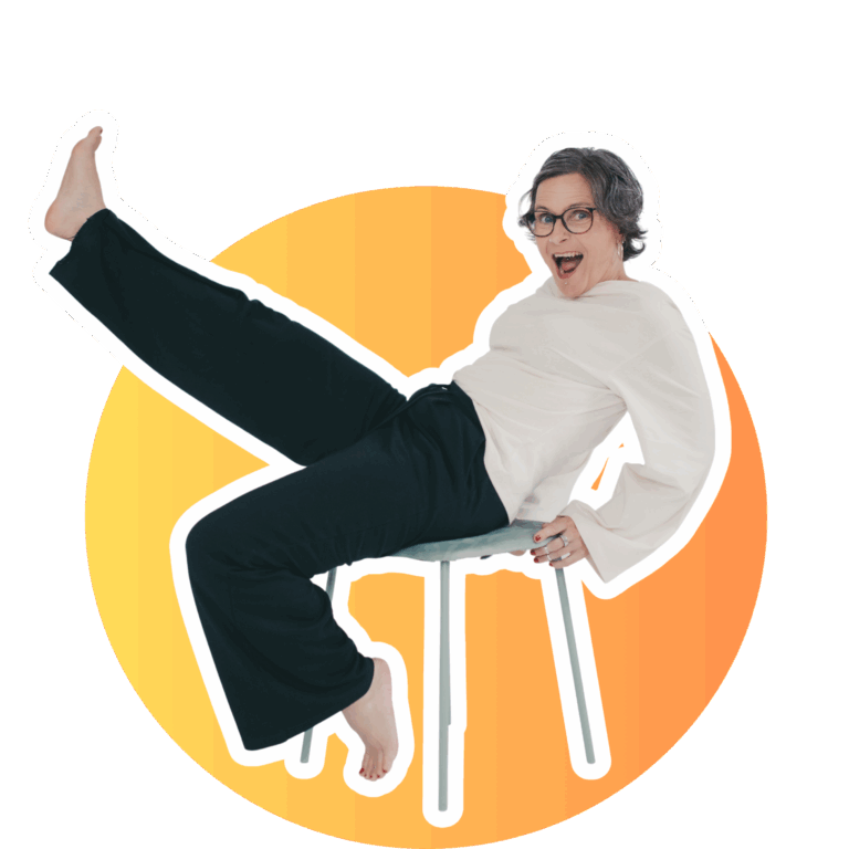 Inga auf Hocker, nach hinten gelehnt, ein Bein in der Luft, fröhlicher Blick